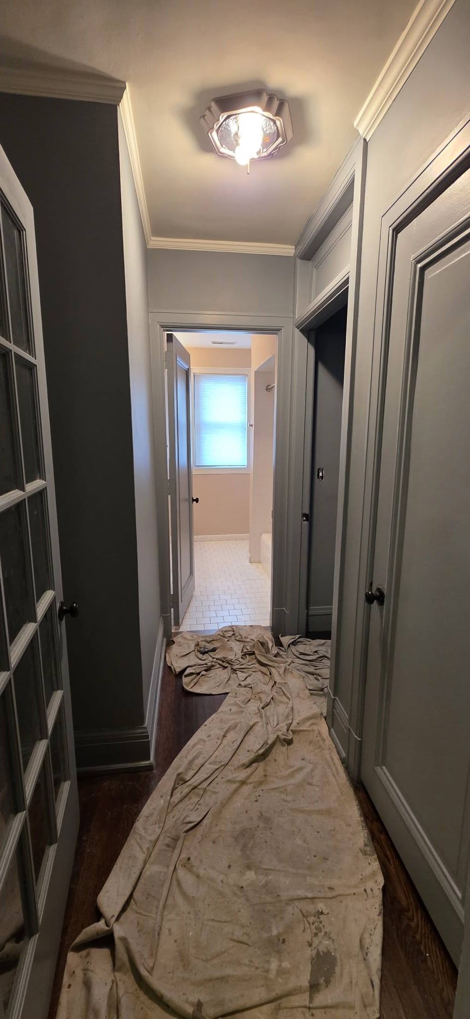 Hallway with dark gray walls and white trim
